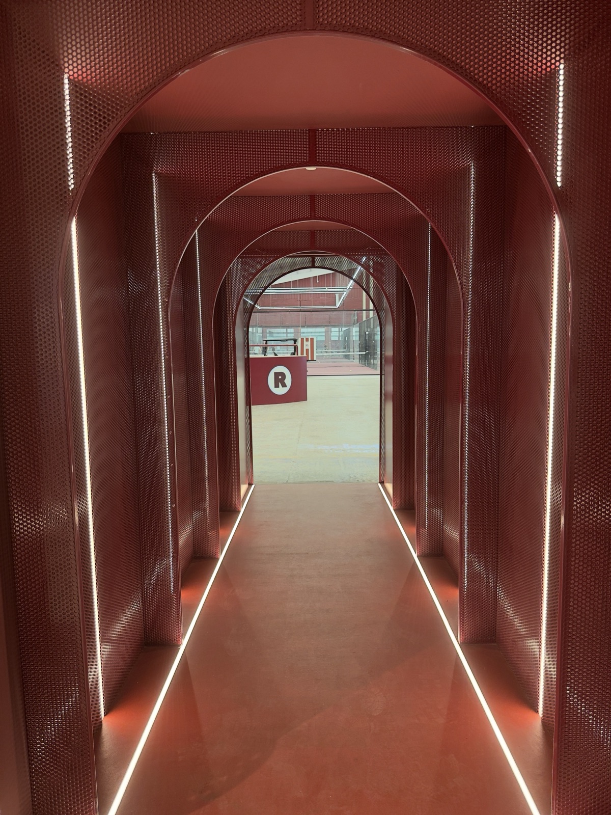 The red arched player tunnel leading to the courts at Racketeer.