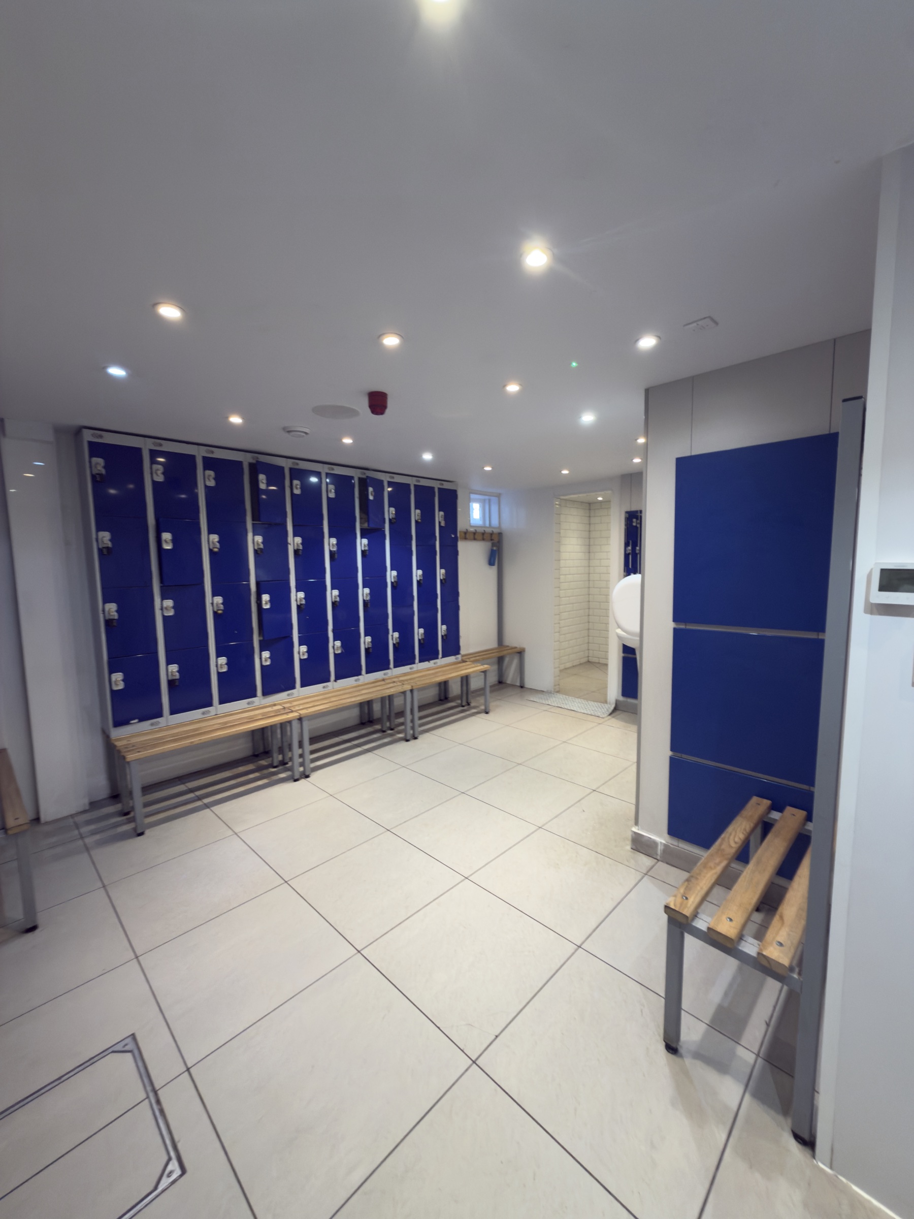 The Rocks Lane Chiswick changing rooms: polished tile, dated lockers.