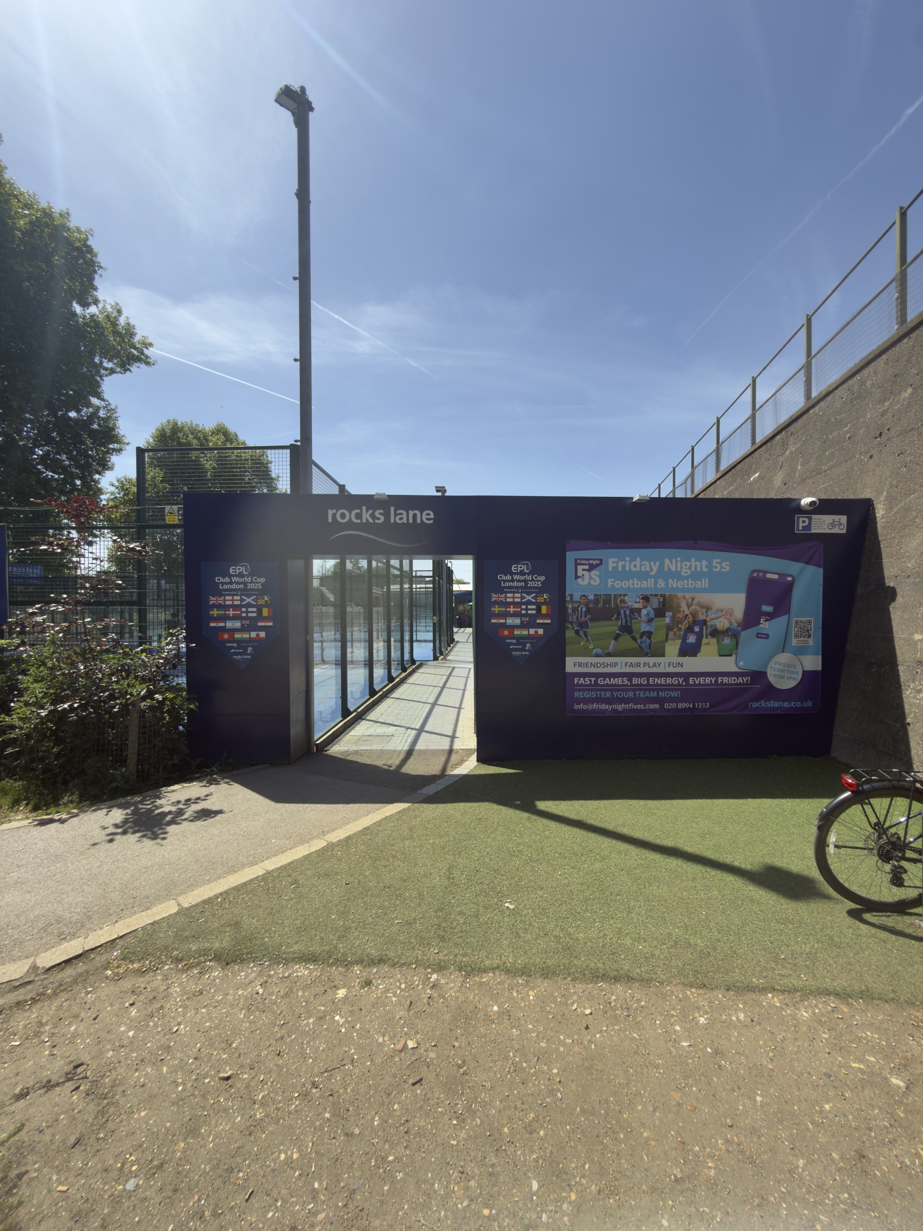 The purple entrance to Rocks Lane Chiswick, with EPL Club World Cup and Friday Night 5s banners.