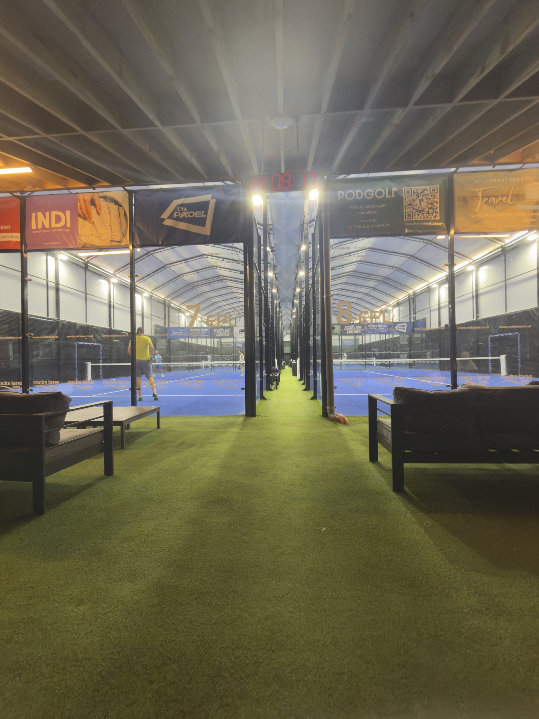 The covered courts at Rocks Lane Chiswick, mid-afternoon. The seating sits in front, empty.