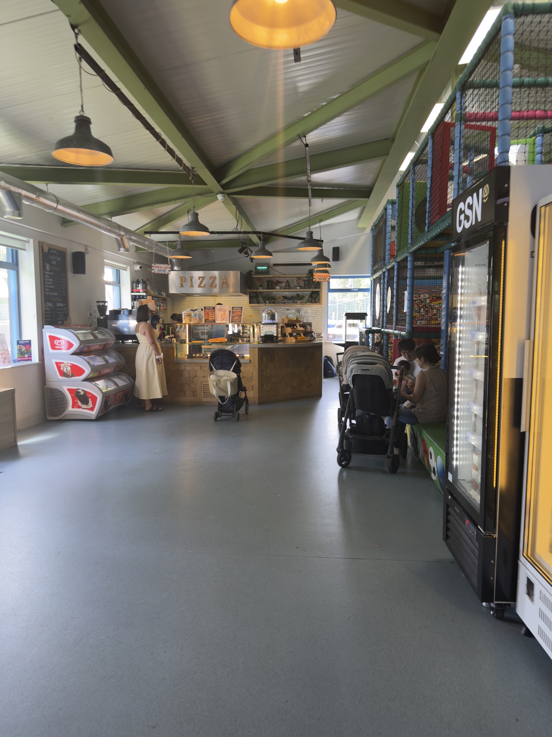 The pizza counter and children's climbing frame in the Rocks Lane Chiswick café.